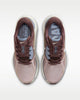 Pair of maroon and beige running shoes on a white background
