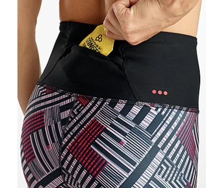 Person wearing black athletic shorts with geometric patterned design.