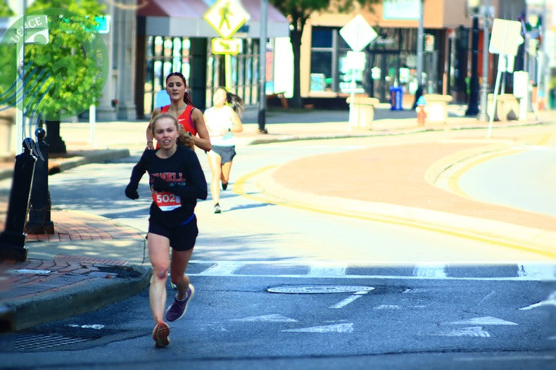 Runners racing through downtown Binghamton during the Greater Binghamton Bridge Run