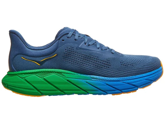 Men's Hoka Arahi 7. Blue upper. Blue and Green midsole. Medial view. 