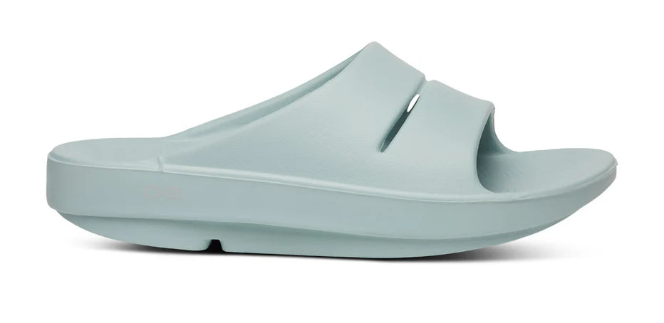 Oofos Ooahh Slide. Light Blue. Lateral view.