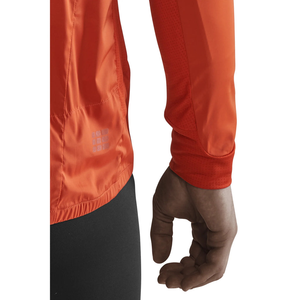 Men's CEP Cold Weather Windbreaker. Dark Orange. Sleeve closeup.